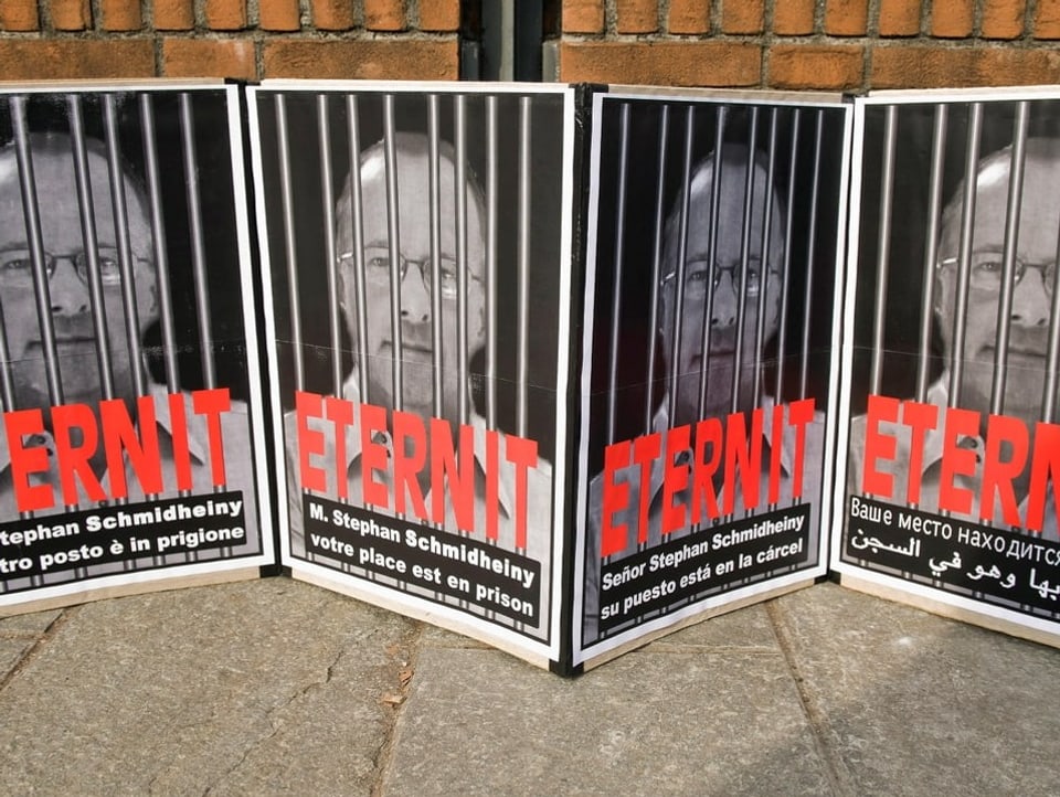 Lined up posters showing Stephan Schmidheiny behind bars