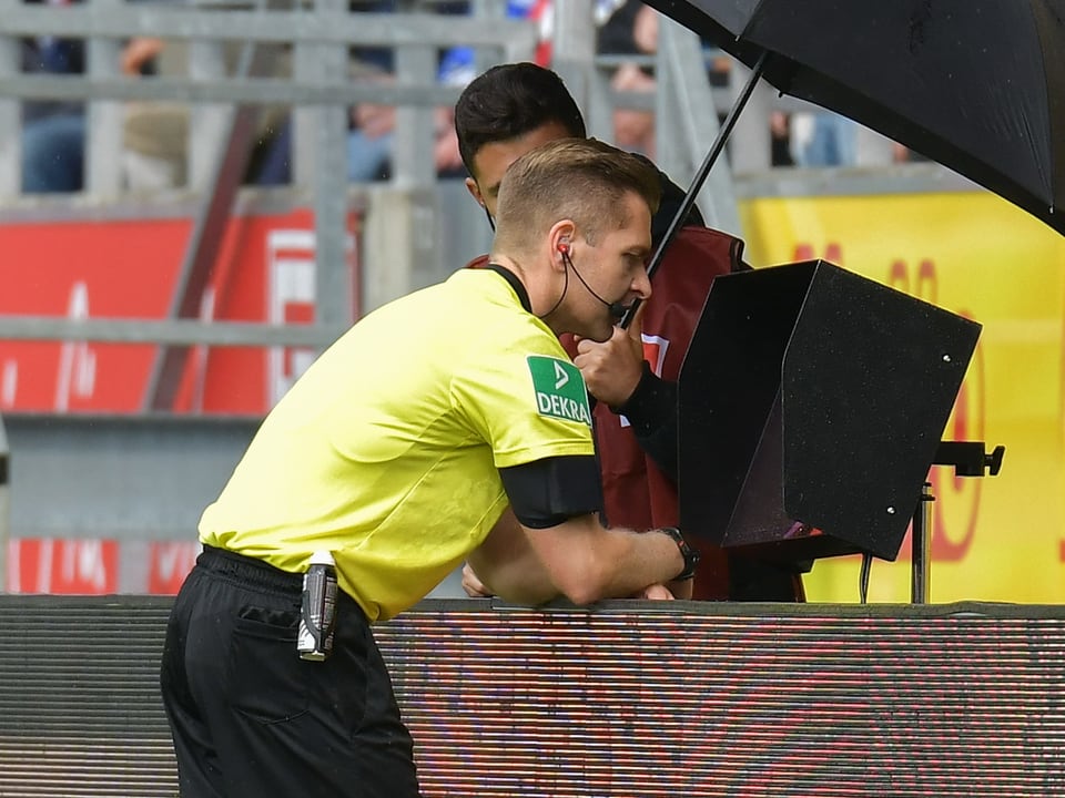 Referee Tobias Welz konsultiert den VAR