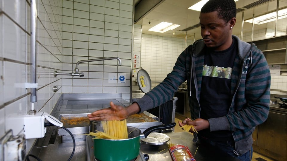 Ein Asylbewerber aus Eritrea in der Küche eines Übergangszentrums in Zürich
